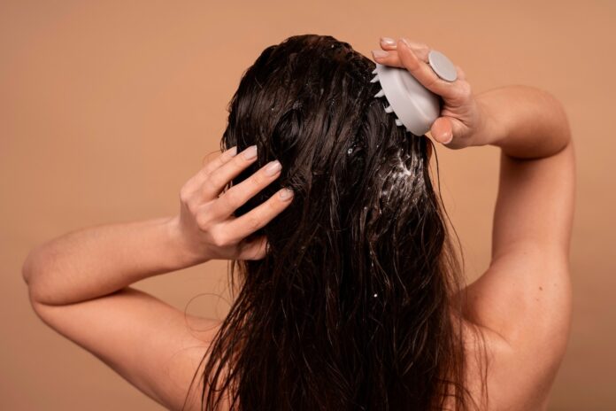 woman use hair massager and shampoo
