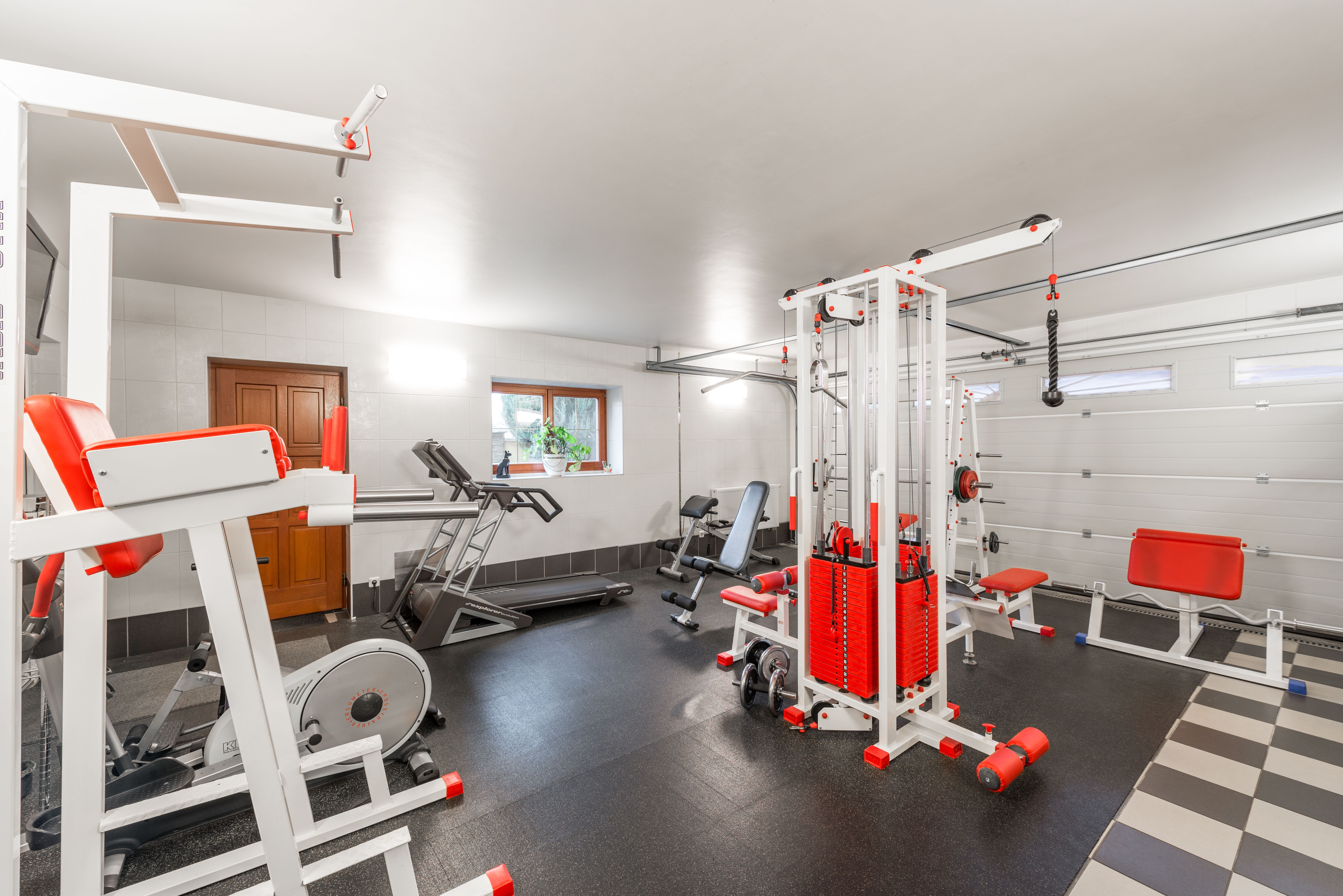 Modern spacious home gym for strength training in the garage of a large house